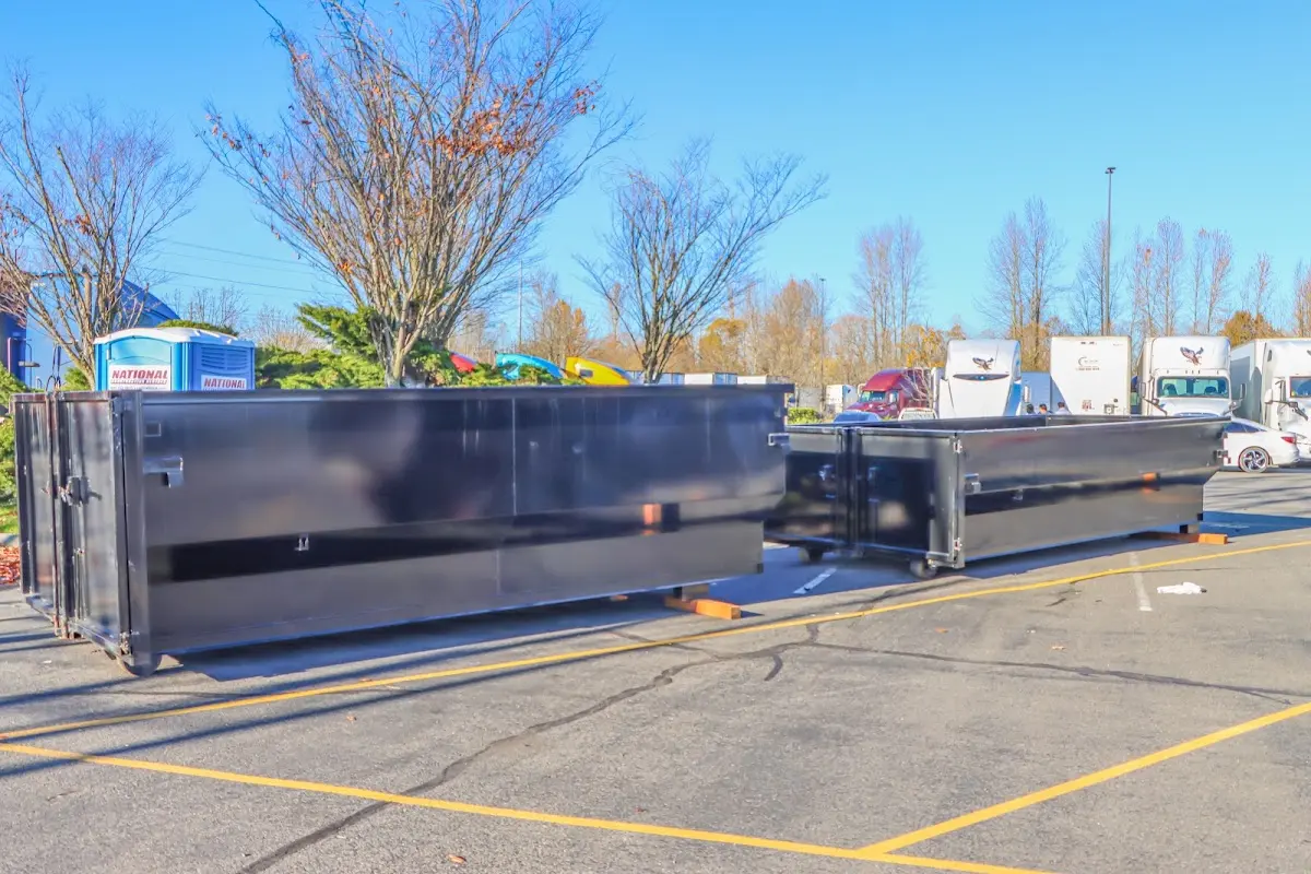 Professional dumpster rental service with roll-off container on residential driveway in Sumter